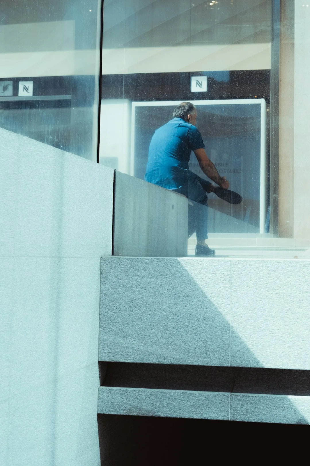 Top view of workers cleaning a large surface with equipment and water hoses.